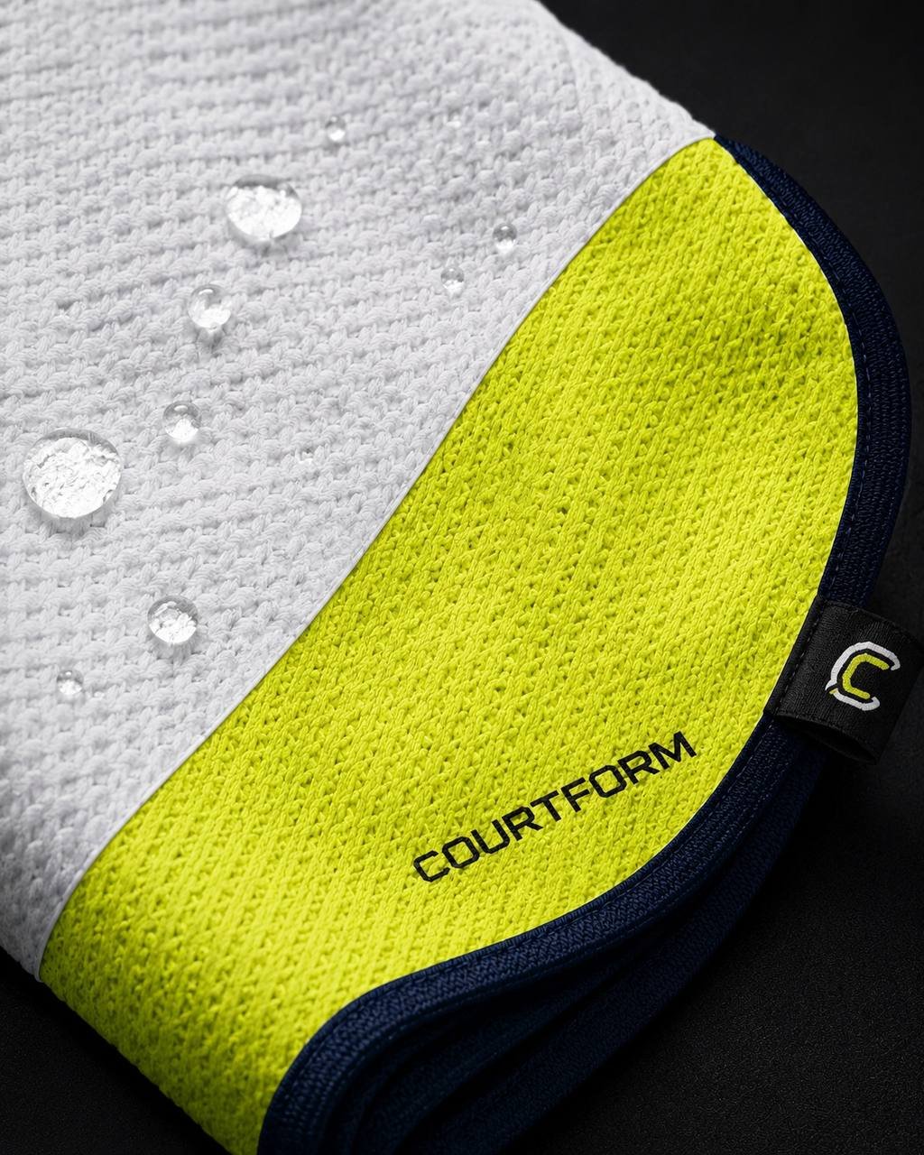 Macro shot of water droplets absorbing into Courtform Pro waffle microfiber